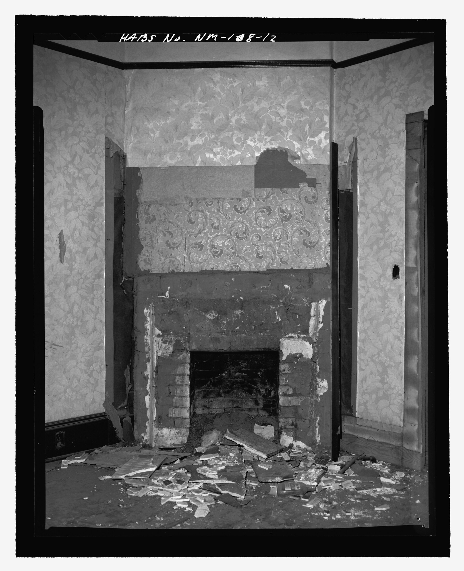 A traditional adobe fireplace with hand-finished plaster and a small mantle of vessels