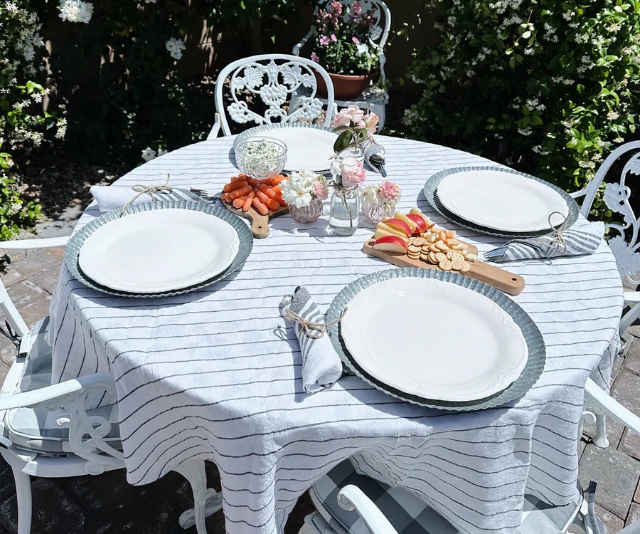 A round linen tablecloth dressed on a wooden table